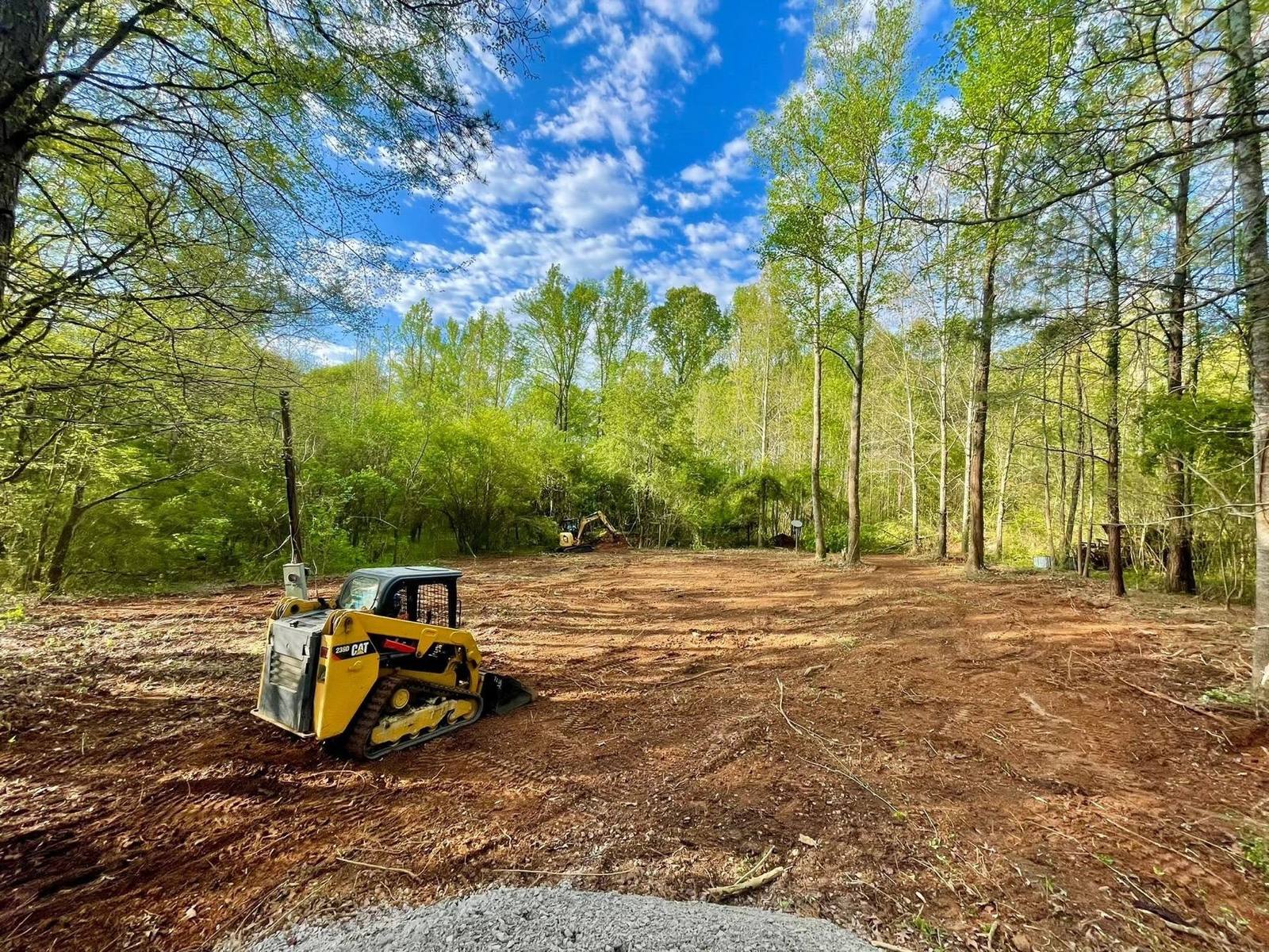 Compact track loader grading a residential lot