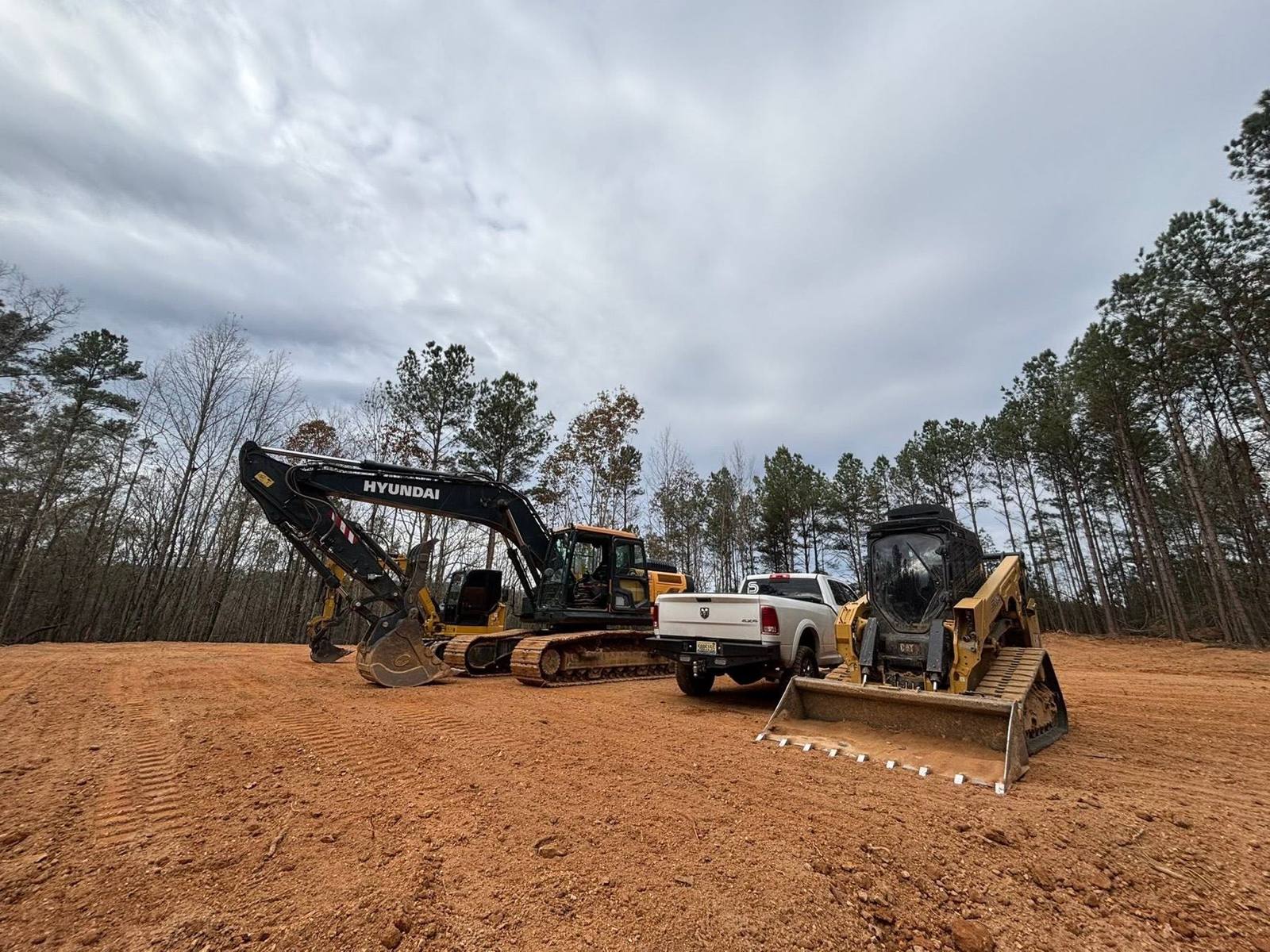 Cleared pine lot with equipment on site